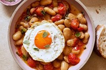 Braised butter beans with crispy fried eggs