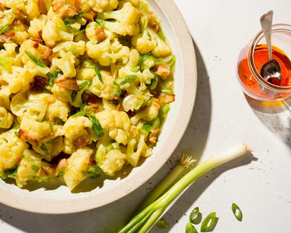 Braised cauliflower with garlic, bacon and scallions
