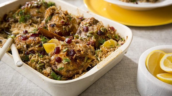 Braised chicken with spiced rice, cranberries and dill