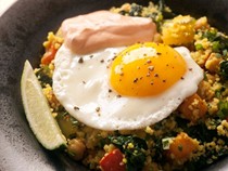 Braised chickpeas and vegetables with couscous, harissa yogurt, and soft eggs