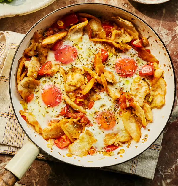 Braised eggs with pitta, tomatoes and za'atar