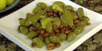 Braised green olives with roasted almonds