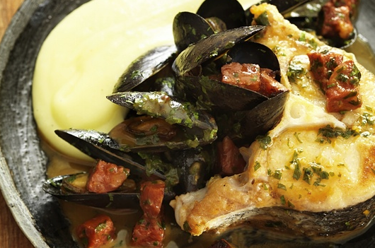 Braised hake with mussels, chorizo and olive oil mash