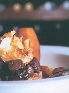 Braised haunch of venison with celeriac purée, roast root vegetables and kümmel cream