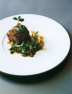 Braised lamb with peas, broad beans and celeriac purée