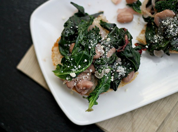 Braised mixed greens and garlicky beans on toast