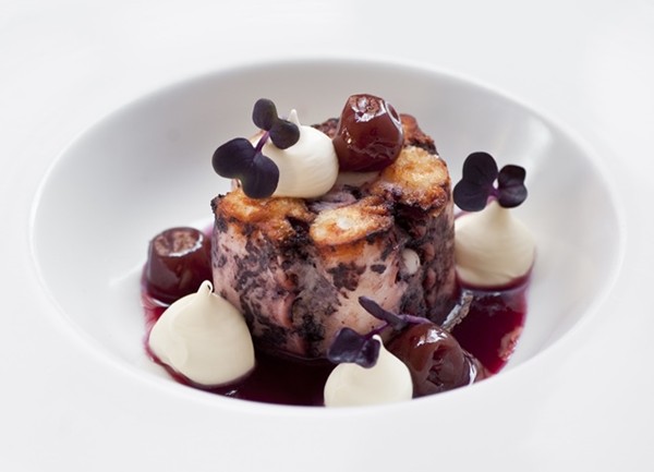 Braised octopus with sour cherries, sour cream and rosemary smoke