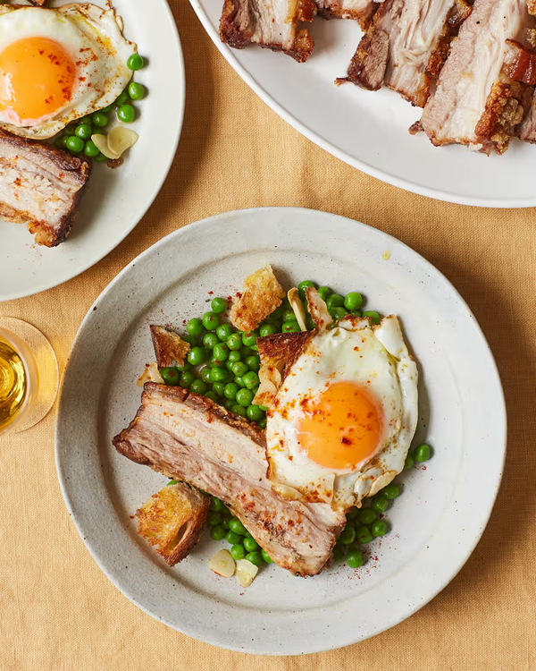 Braised pork belly with fried eggs and peas