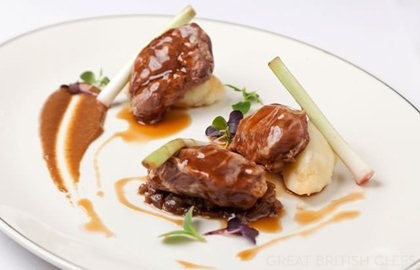 Braised pork cheeks with baby leeks, sultana ragu, mash and caraway jus
