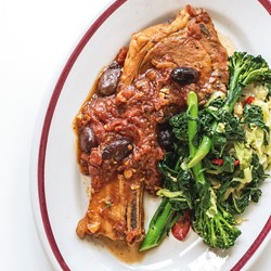 Braised pork chops with tomato sauce and fried greens