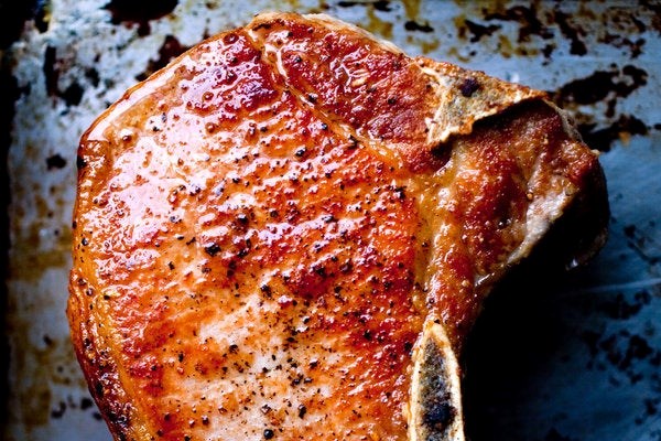 Braised pork chops with tomatoes, anchovies, and rosemary