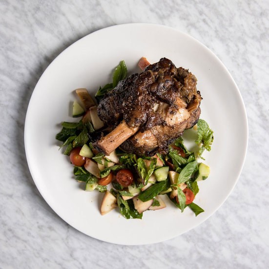 Braised pork shanks with grilled peach salad