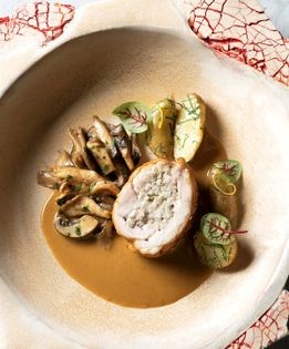Braised rabbit leg "paupiette" with rosemary-garlic stuffing, wild mushrooms, and chervil sauce
