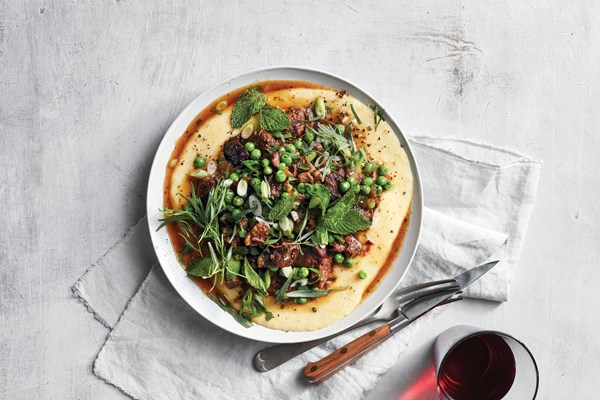 Braised Roman-style lamb with herbs and peas