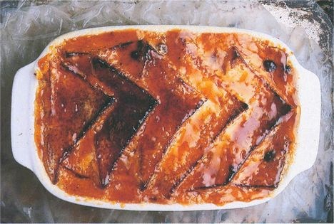 Bread and butter pudding served with clotted cream and compote of apricots