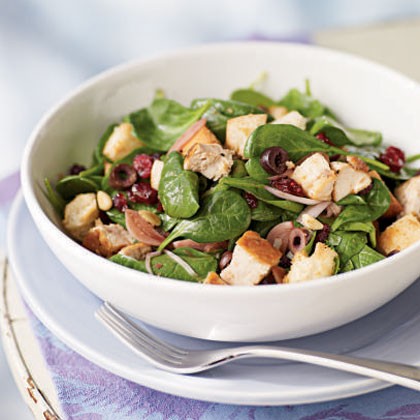 Bread salad with cranberries, spinach, and chicken