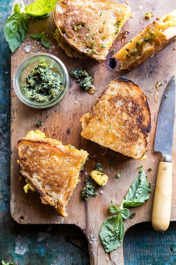 Breakfast grilled cheese with soft scrambled eggs and pesto
