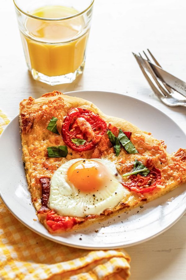 Breakfast pizza with cheddar, bacon, and eggs