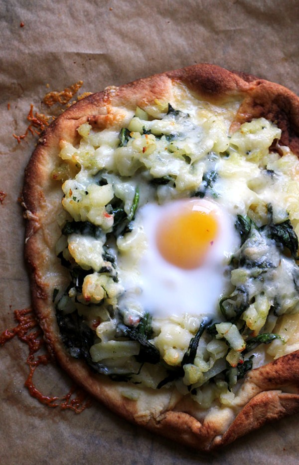 Breakfast pizza with hash browns, spinach, and eggs
