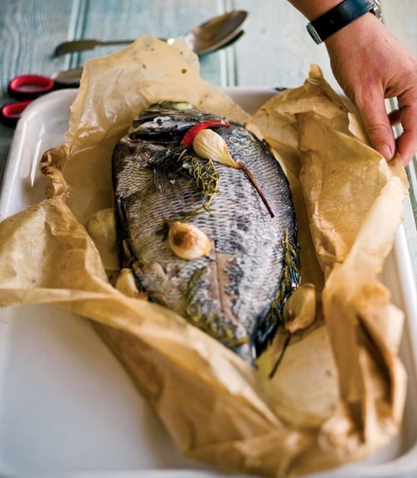 Bream cooked en papillote with garlic, chilli and rosemary