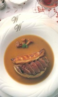 Breast of wood pigeon on a pastry case filled with wild mushrooms