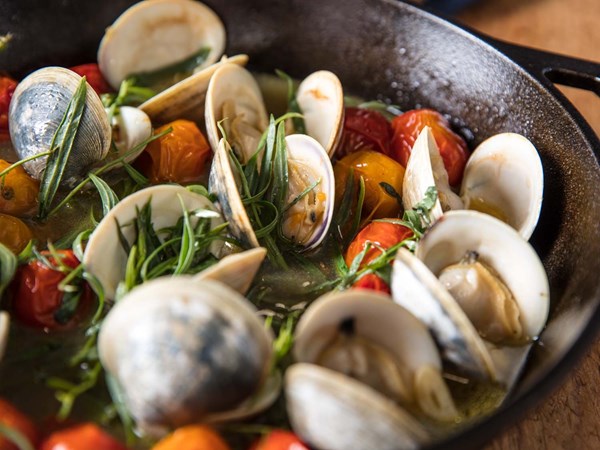 Broiled clams with tomatoes, butter, and tarragon