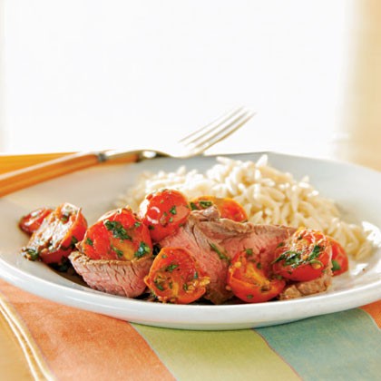 Broiled flank steak with warm tomato topping