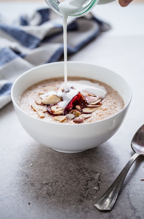 Broken farro porridge with coconut milk, almonds, & roasted plums