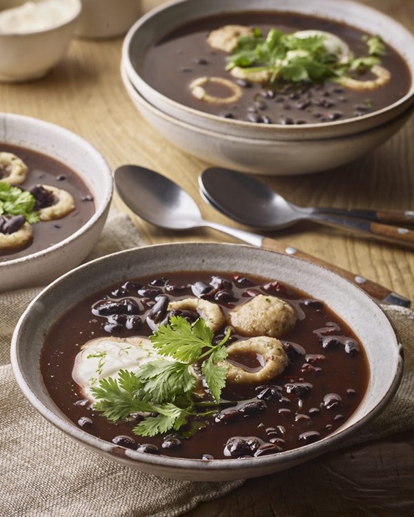 Brothy lime and chilli black beans with corn dumplings 