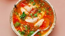 Brothy tomato and fish soup with lime