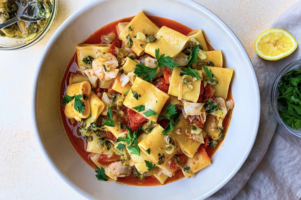 Brothy tomato pasta with white fish, shallots & capers