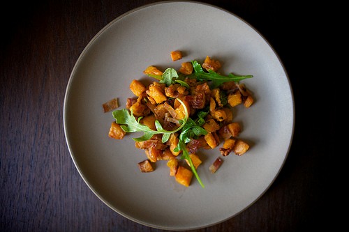 Brown butter-roasted sweet potatoes with arugula and bacon