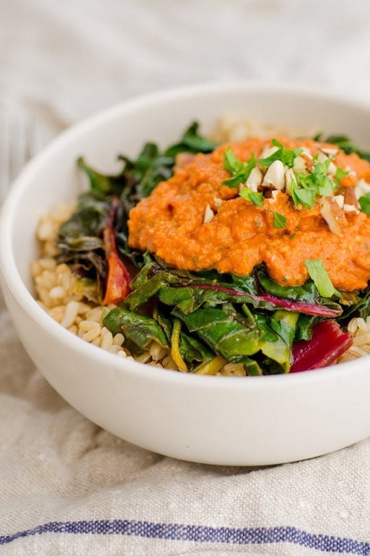 Brown rice bowl with chard & nutty tomato romesco sauce