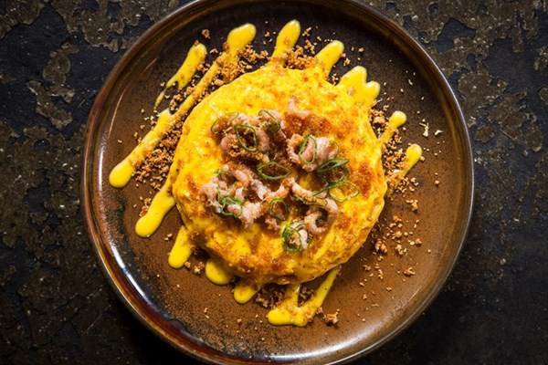 Brown shrimp kaygana, preserved lemon Hollandaise, çemen crumbs, spring onion and sheep's cheese