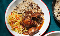 Brown stew chicken with rice and peas