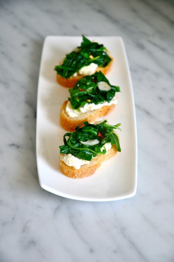 Bruschetta of wilted bitter greens and ricotta salata