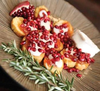 Bruschetta topped with apricot, melted Brie, and pomegranate seeds