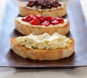 Bruschetta with grape tomato, white bean puree, and rosemary topping