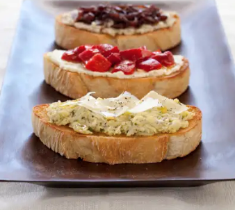 Bruschetta with olive pesto, ricotta, and basil