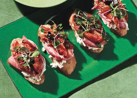 Bruschetta with rosemary, roasted plum tomaties, ricotta, and prosciutto