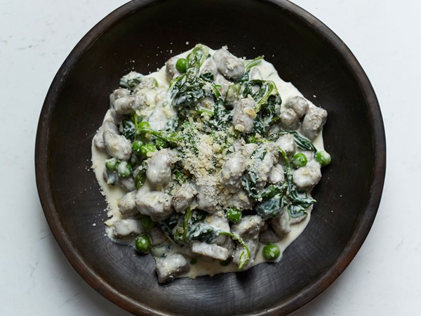 Buckwheat and ricotta gnocchi with cream, peas, and spinach