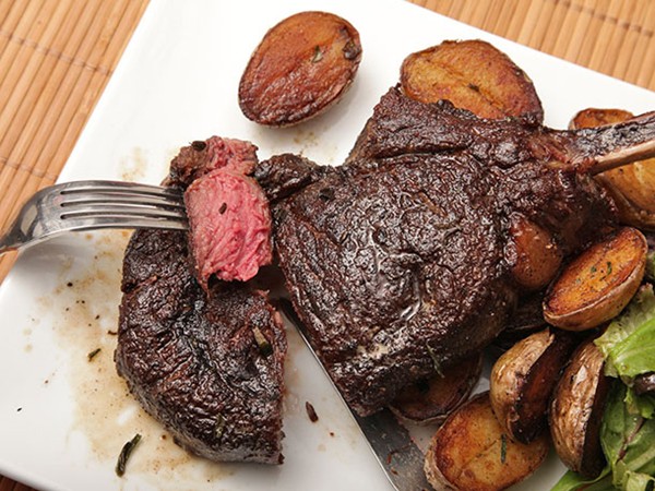 Butter-basted bison ribeye steak with crispy potatoes