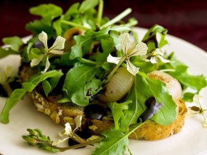Butter-braised cipollini onions with arugula and balsamic syrup on mountain multi-grain toast