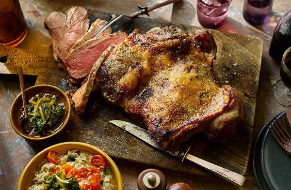 Butterflied leg of lamb with aubergine, roast tomatoes, mint, honey & preserved lemon relish
