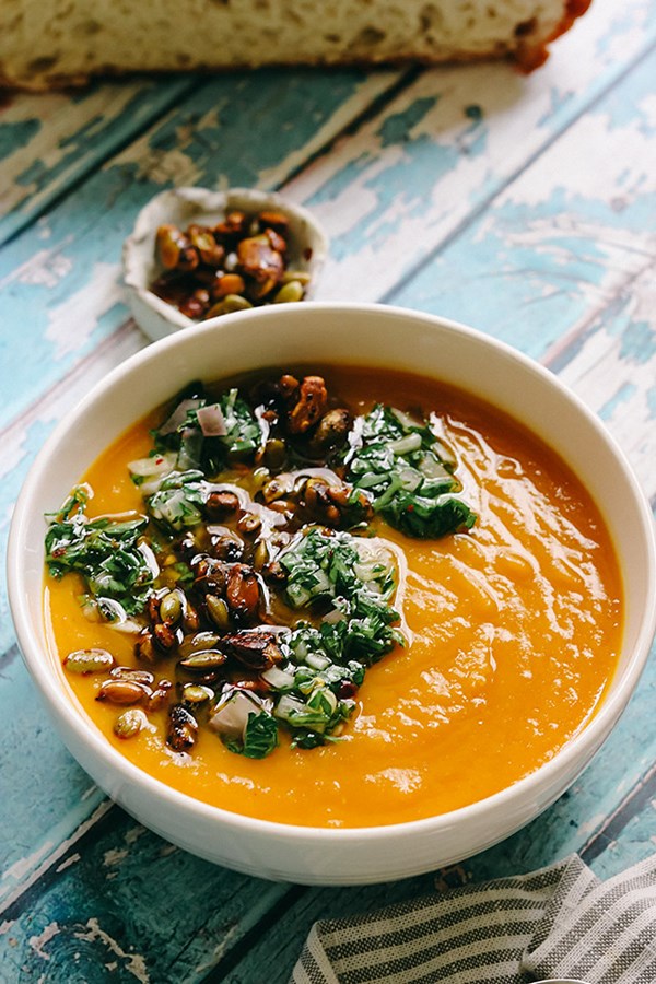 Butternut squash and saffron soup with caramelized pistachios and herb oil