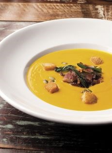 Butternut squash soup with apple-bacon relish and toasted butternut squash seeds