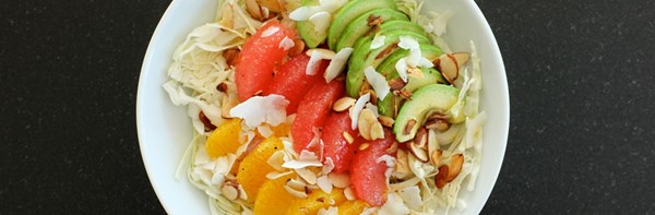 Cabbage bowl with citrus, avocado, almonds, and coconut