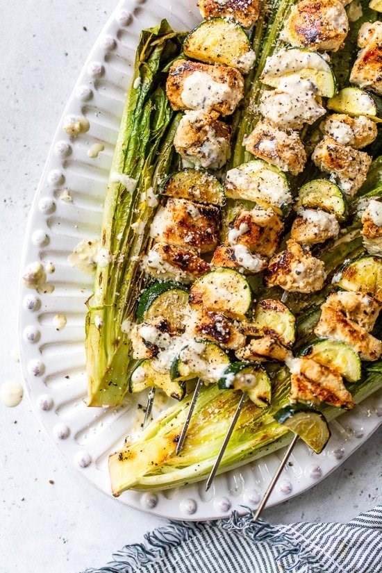 Caesar-marinated chicken kabobs with zucchini and grilled romaine