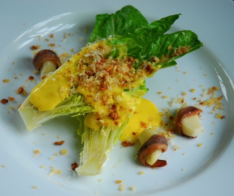 Caesar salad with anchovy wrapped garlic and savory lemon sabayon