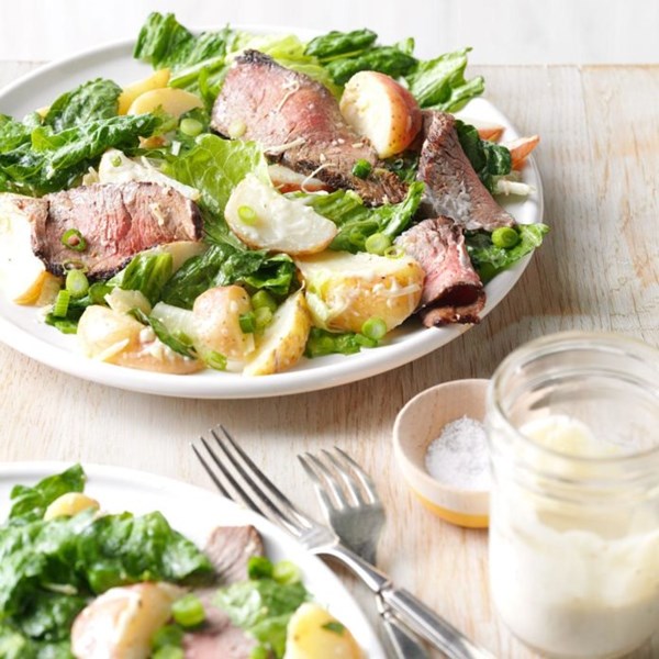 Caesar salad with grilled steak and potatoes